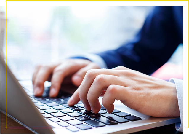 A person typing on a laptop computer.